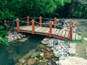 A wooden bridge crossing over a river.
